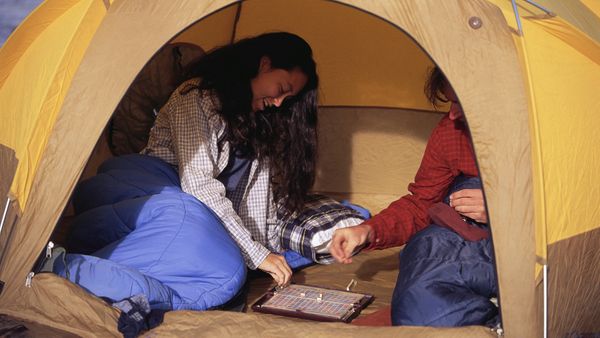 play travel scrabble game in tent