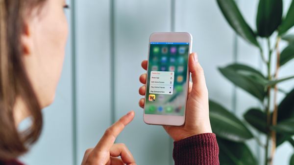 Woman deleting Words With Friends app on phone