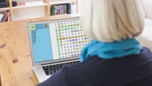 woman playing free word search game on laptop