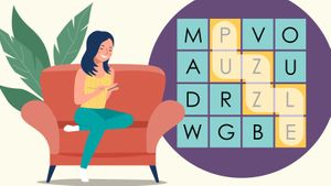 woman on sofa playing word search game