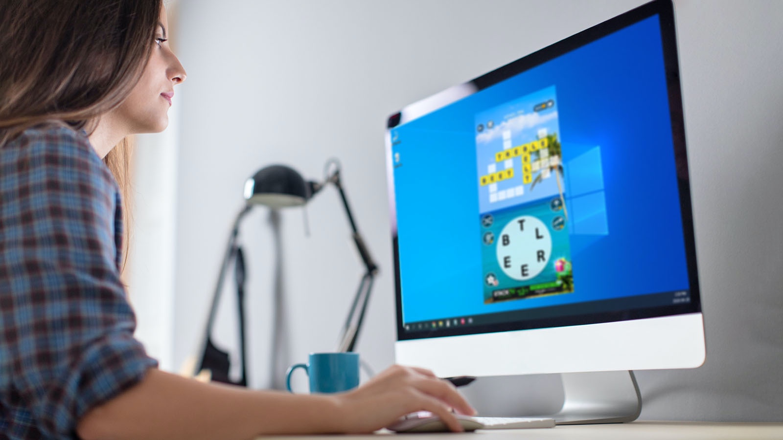 Woman playing Wordscapes on computer