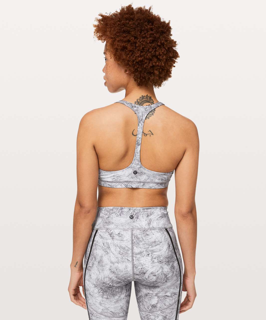 https://storage.googleapis.com/lulu-fanatics/product/46212/1280/lululemon-arise-bra-reflective-lululemon-lab-alabaster-print-white-multi-039774-265933.jpg