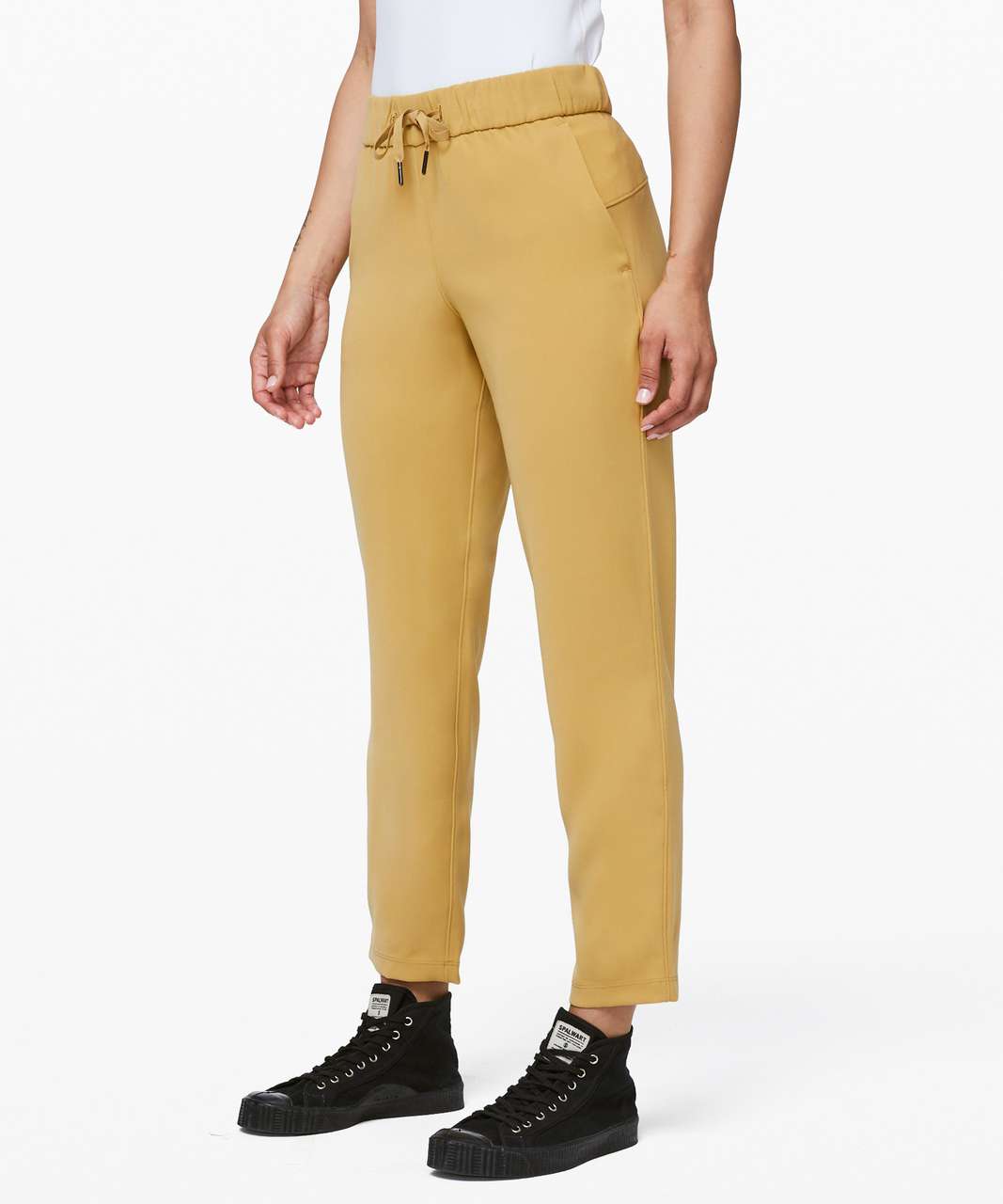 https://storage.googleapis.com/lulu-fanatics/product/47560/1280/lululemon-on-the-fly-7-8-pant-woven-vintage-gold-038295-273415.jpg