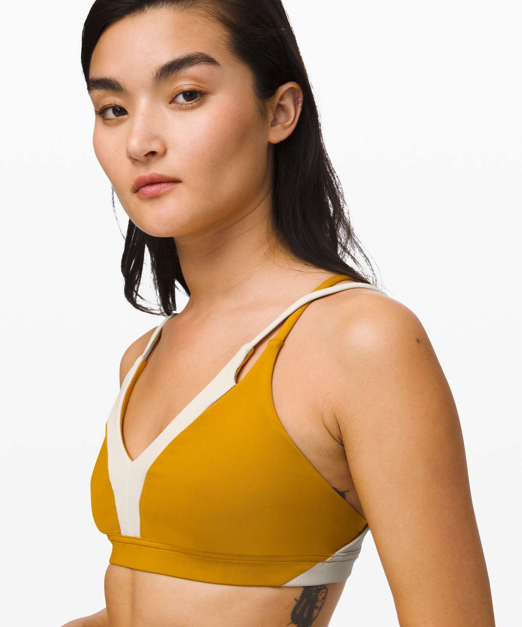 https://storage.googleapis.com/lulu-fanatics/product/52769/1280/lululemon-new-ambition-bra-fools-gold-light-ivory-043117-300377.jpg