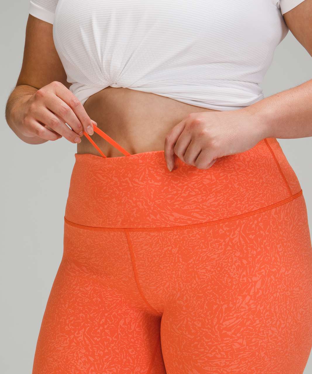 https://storage.googleapis.com/lulu-fanatics/product/64432/1280/lululemon-wunder-train-high-rise-short-8-crunch-warm-coral-049643-353717.jpg