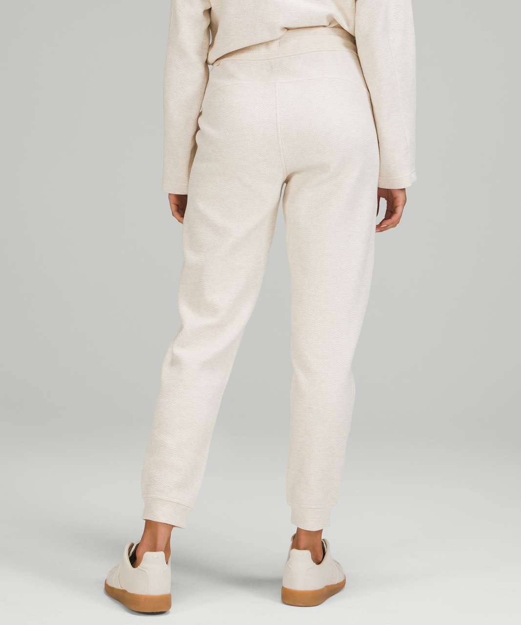 https://storage.googleapis.com/lulu-fanatics/product/67102/1280/lululemon-ribbed-high-rise-jogger-25-7-8-length-heathered-white-opal-047855-365484.jpg