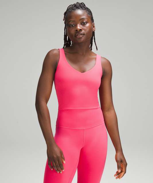 Three different pairings of the Feather Pink Align Tank (6). Still