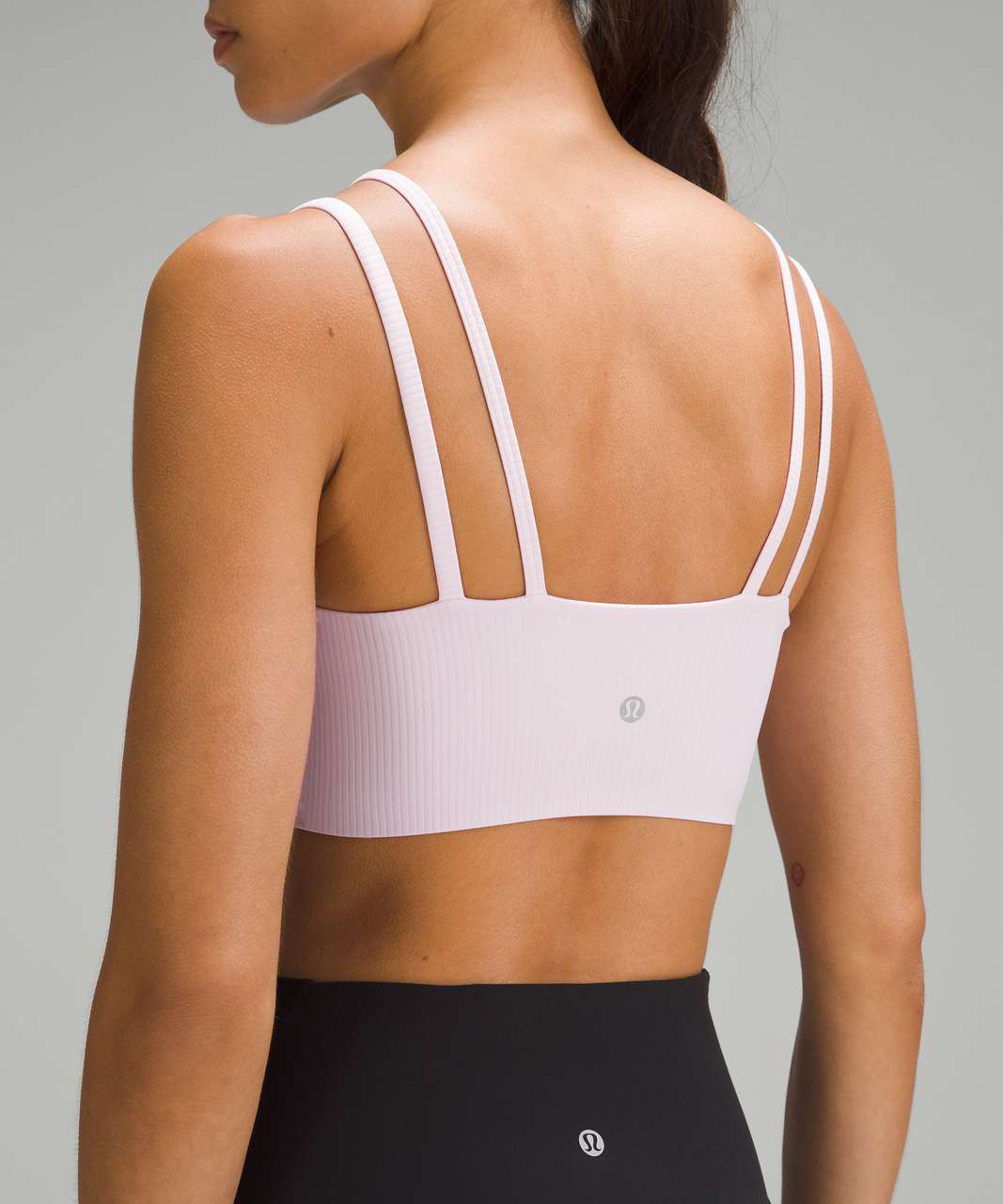 Lululemon sports bra thin stripes strappy back in pink and white. There is  no size listed but fits like small.