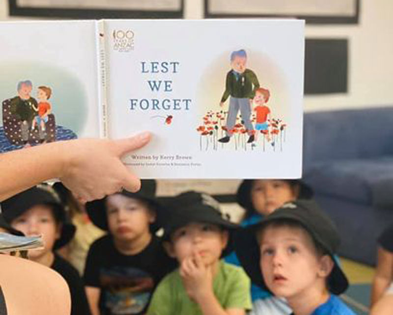 Preschoolers listen to a reading of Lest We Forget by Kerry Brown, a children's book about Anzac Day.