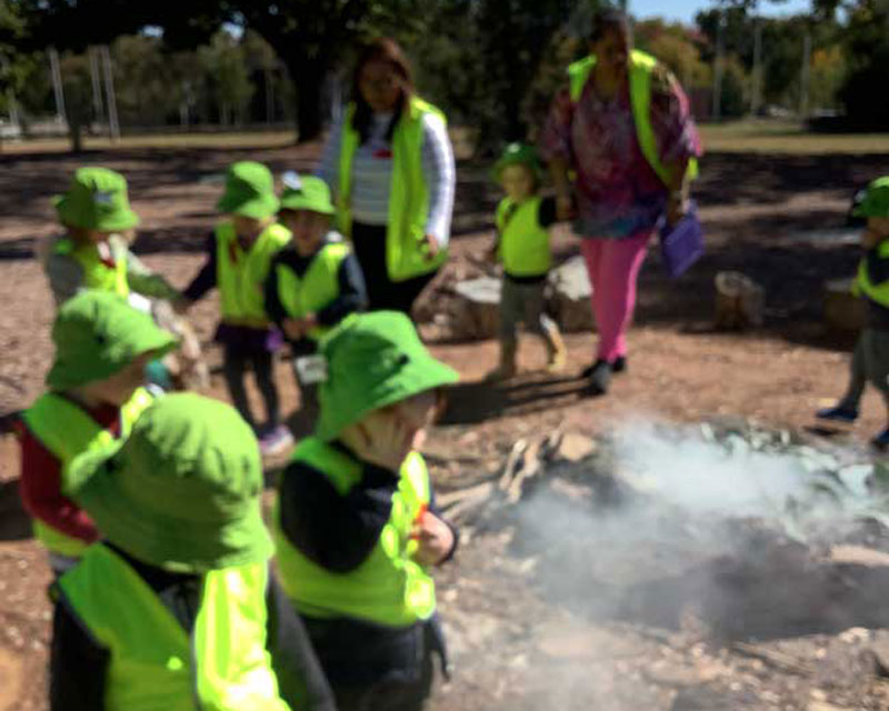 Children join a Aboriginal smoking ceremony. NAIDOC Week is important for its learning opportunities.