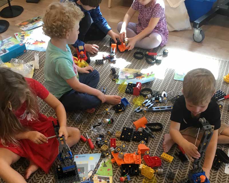 Children play indoors with toys. Controlling and assessing risks occur regularly in studios and outdoor areas.