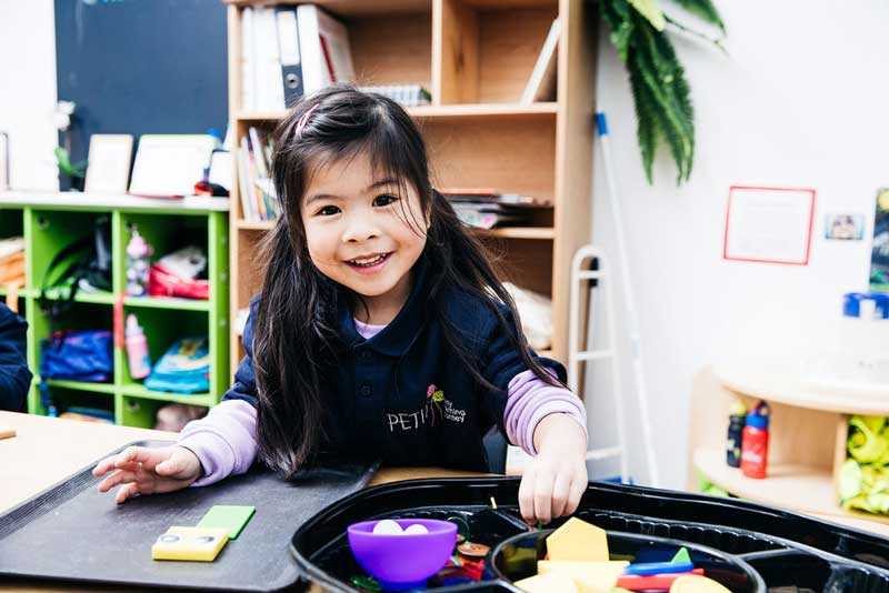 Preschooler enjoying the child-led teaching strategies in early childhood education.