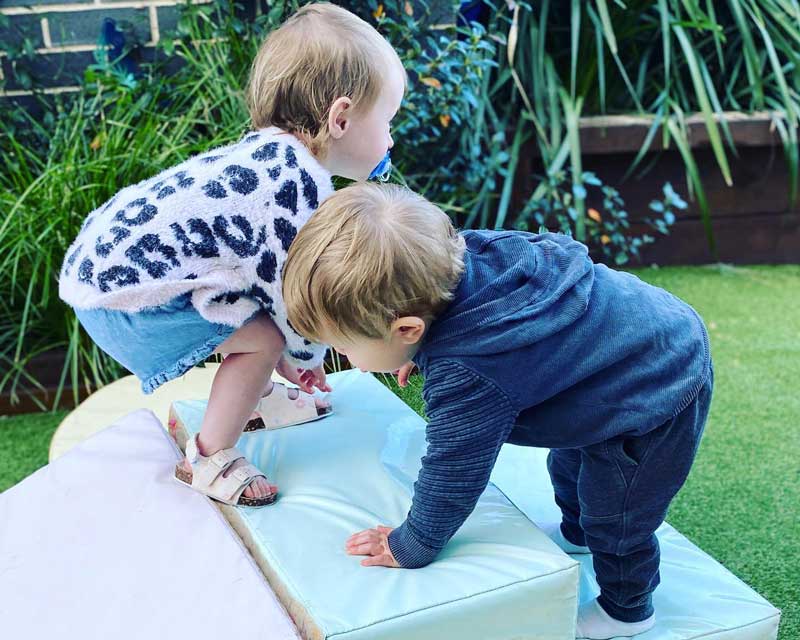 Children participate in outdoor activities like climbing. Helping children to help themselves.