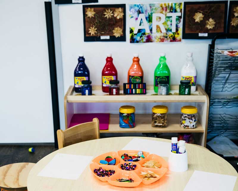 Colourful sand bottles on display in the art corner