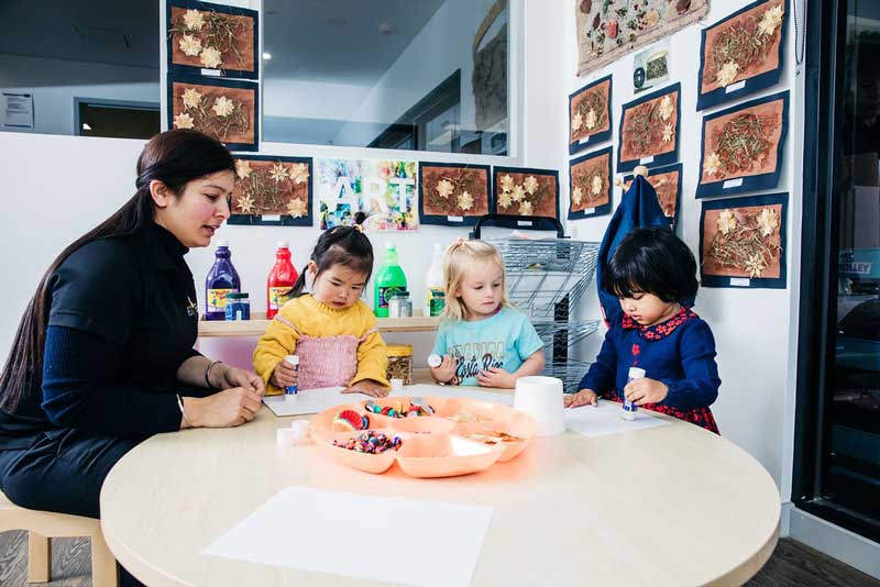 Children use loose parts to make DIY Father's Day gifts.