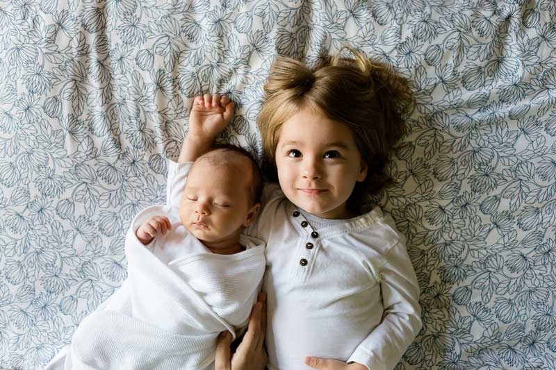 Newborn and older sibling sharing experiences helps to prevent sibling jealousy.