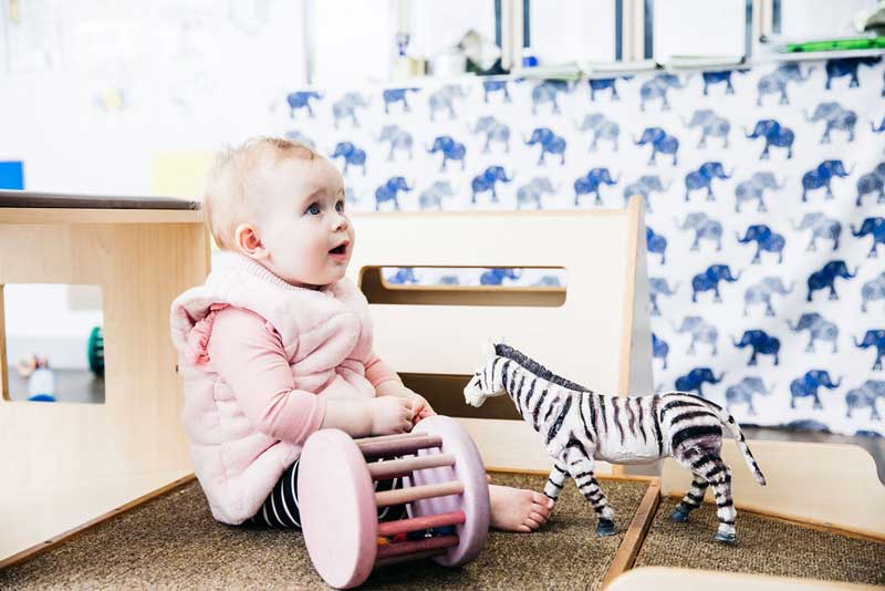 Baby sits up without support , one of the many baby development milestones.