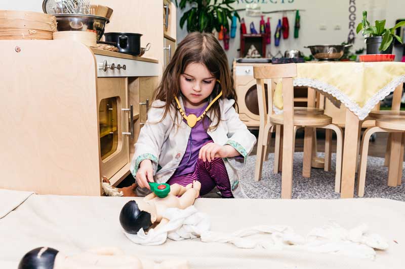 Child dresses up as a doctor. Cleaning games can include roleplay and dressup.