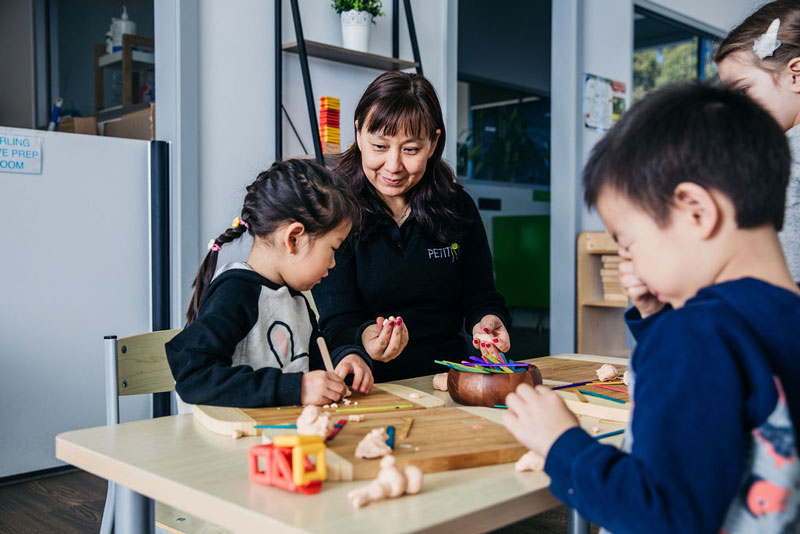 Children play with clay to build-up hand strength an essential building block for emergent pre-writing skills.