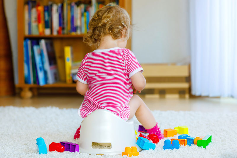 Toilet training tip: Child practises sitting on a potty for potty training