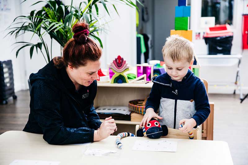 A kid's imagination takes his teddy to school for lessons.