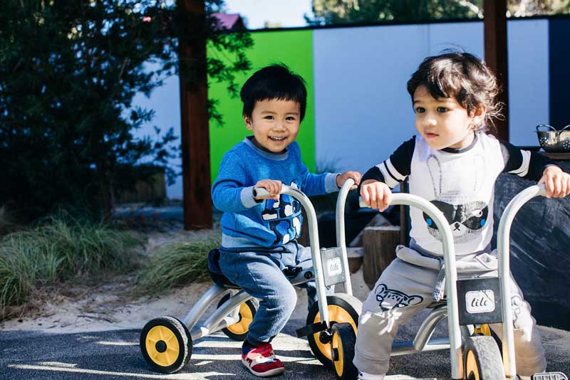 Children play on tricycles as a fun fitness activity for kids
