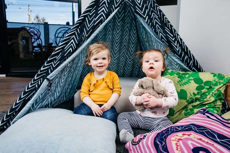 Children hanging out in comfy space. Be prepared for children and include them in a few fun baby shower games.