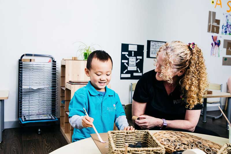 Child uses open-ended loose parts in play-based learning experience