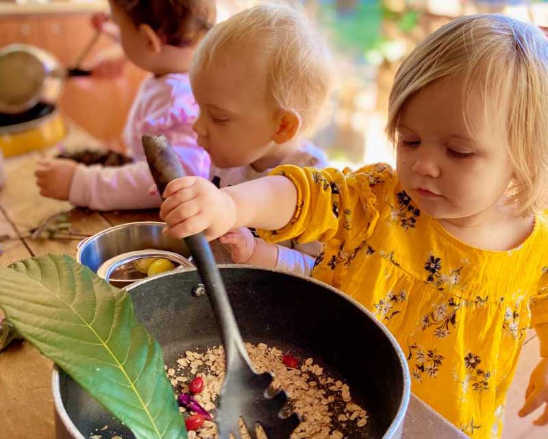 This outdoor kitchen inspires children's creativity with fewer toys and more natural resources and repurposed things.