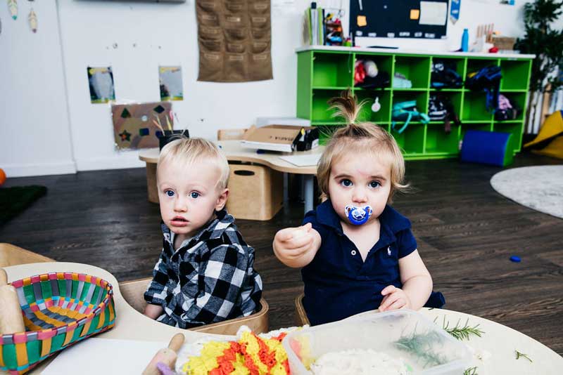 Boy and girl engaging in interests while setting children into care