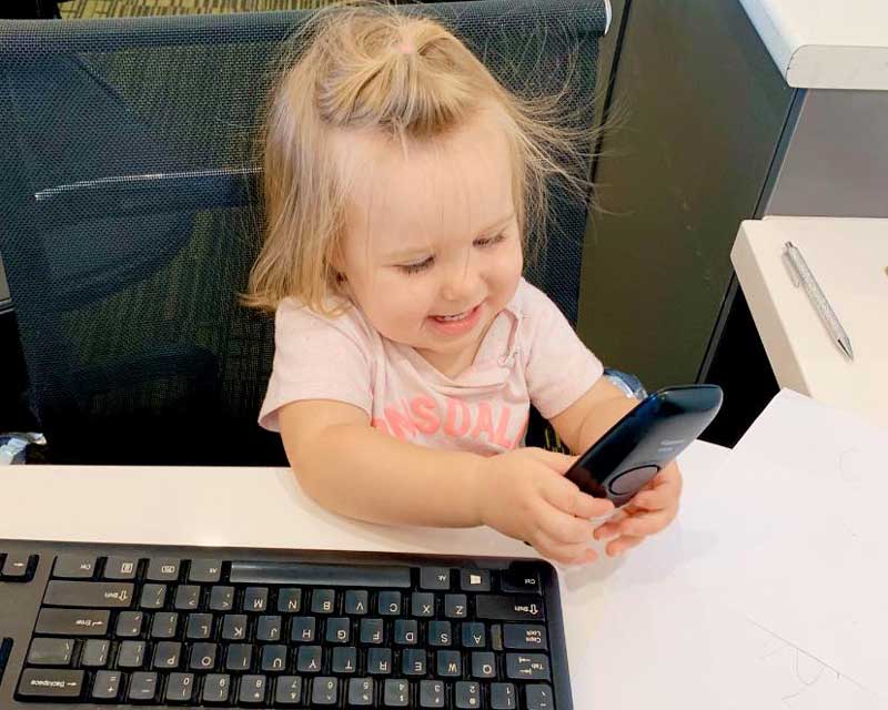 Child takes over the work space, a frequent problem for parents working from home.