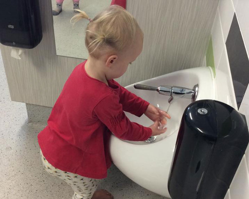 Child washes hands: self care skills for 3-year-olds.