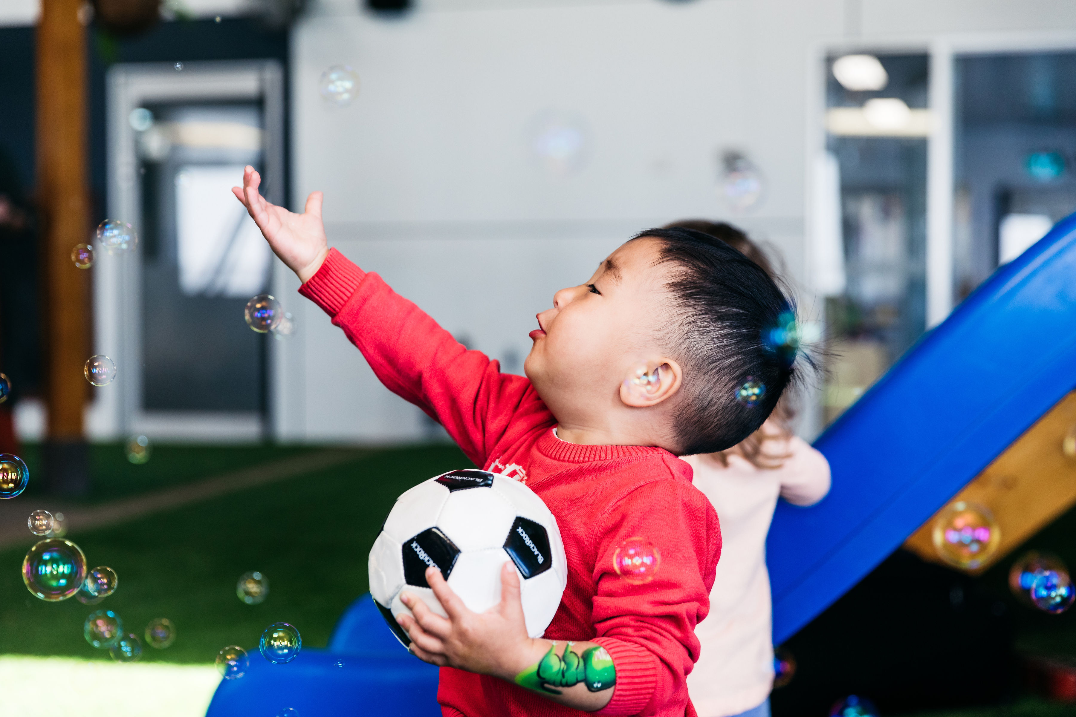 Teaching resilience includes encouraging children to blow bubbles to control their breathing.