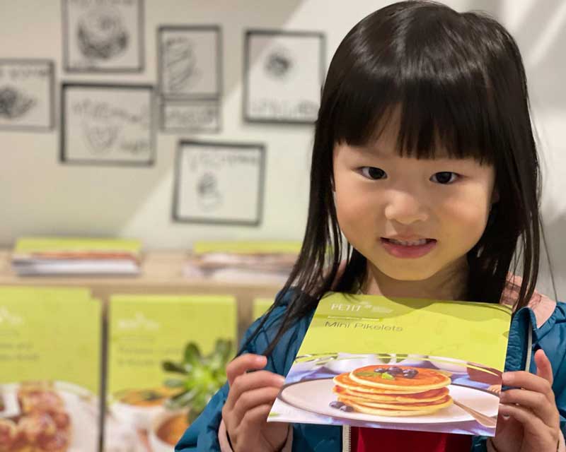 Child holding Petit ELJ's nutritious children's meals.