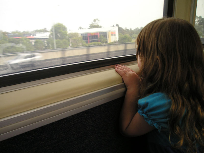 Looking out the train window - travelling with children on a train.