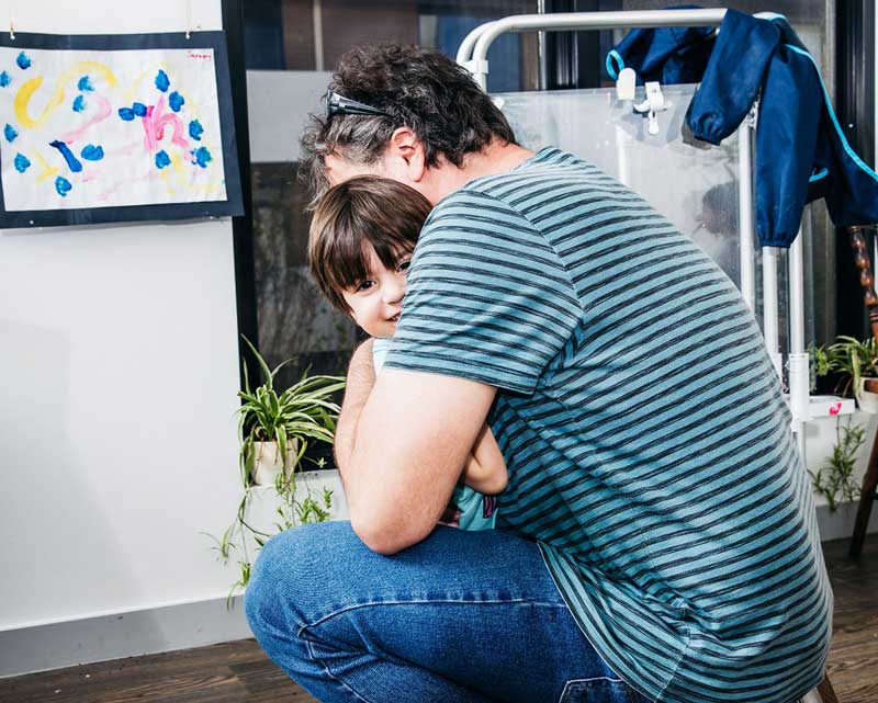 Parent comforts a child with a loved one with a life threatening illness.