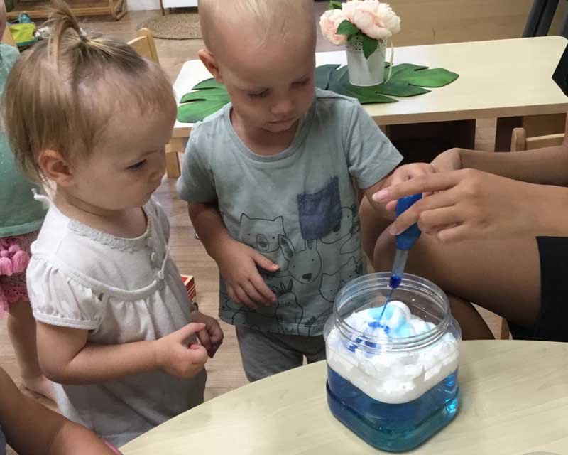 Children observe a rainy day science experiment .