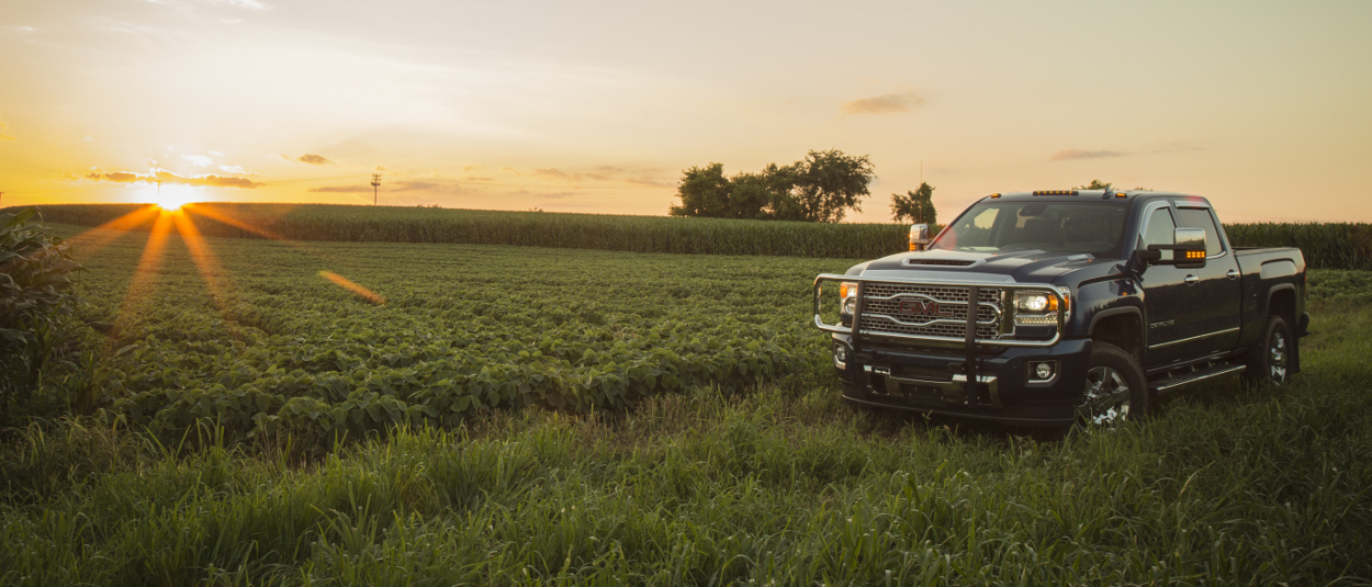 GMC Sierra 3500HD with a LUVERNE grille guard on the farm at sunset