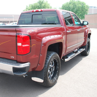 Red Chevrolet Silverado 1500 with rubber mud flaps