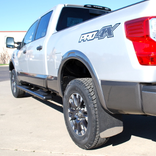 Silver Nissan Titan XD with rubber Mud Guards
