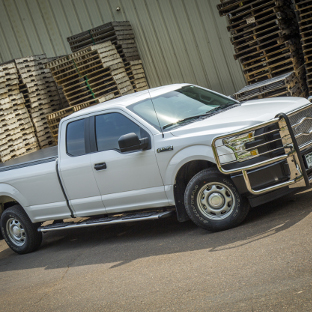 White 2015 Ford F150 with Regal 7™ side steps and grille guard from LUVERNE