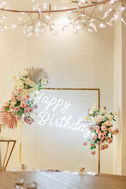 Gold Dress Rack, 'Happy Birthday' Neon Light and Floral Arrangements by Luxe Dream Event Hire and Floral Studio