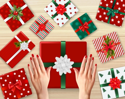 Female hands and decorated cardboard gift boxes of different color realistic background vector illustration