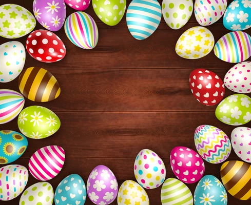 Realistic background with beautiful painted easter eggs on wooden surface vector illustration