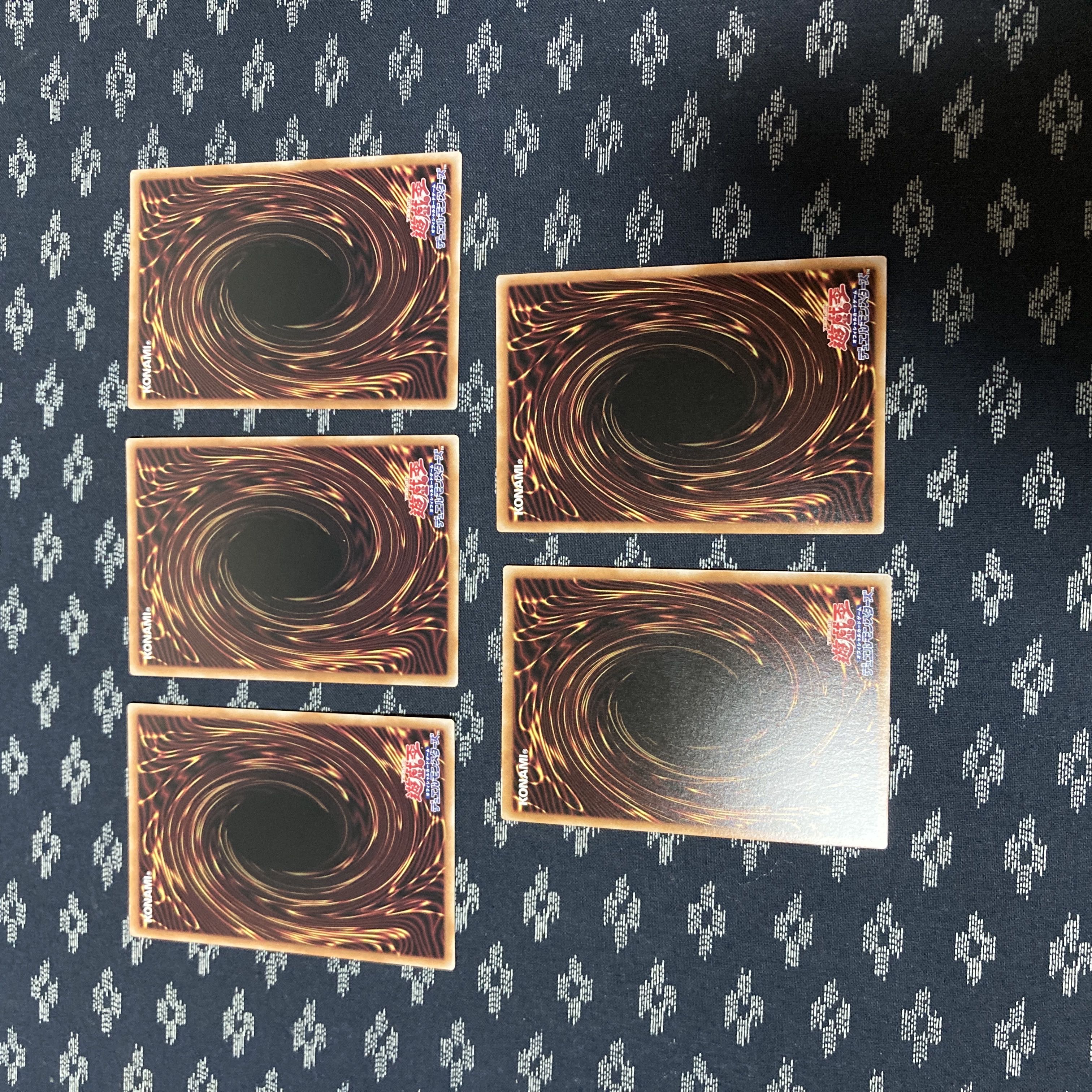 five flat objects (e.g. tickets, pieces of cloth, etc.) Superdreadnought Rail Cannon Juggernaut Liebe (different illustration version) Secret Rare QCAC-JP063