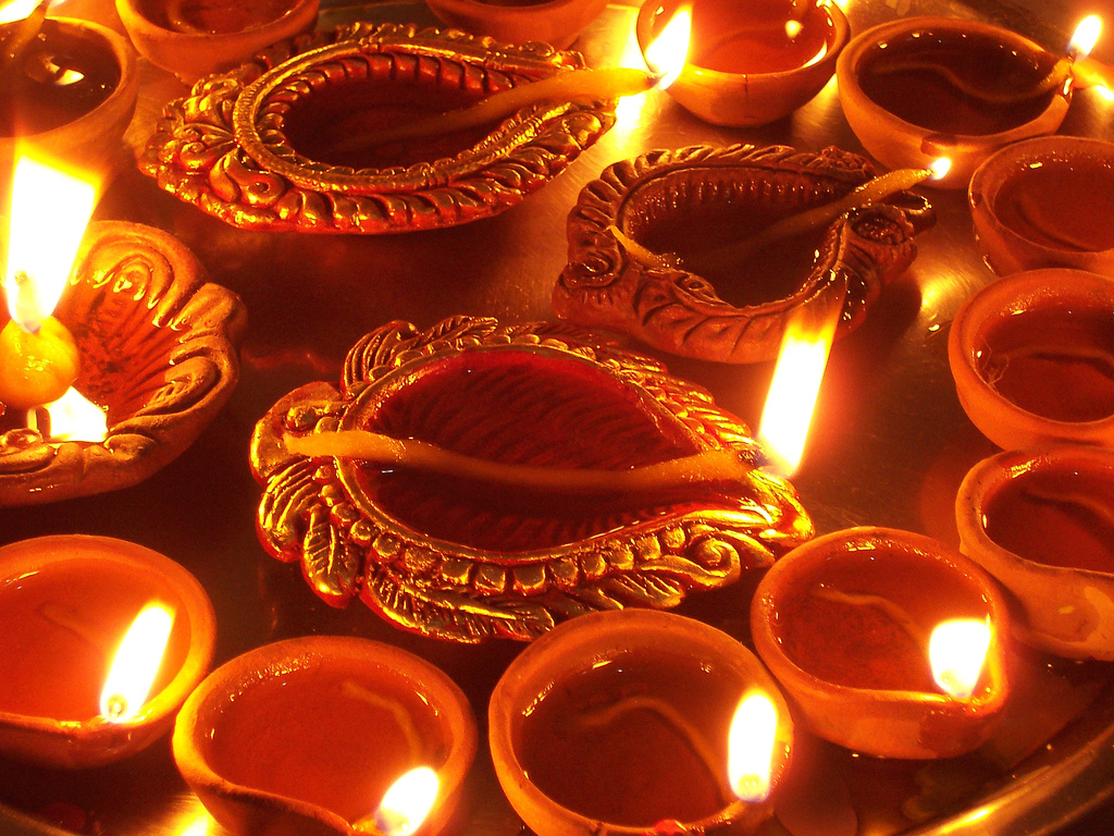 Lit clay diyas arranged for puja