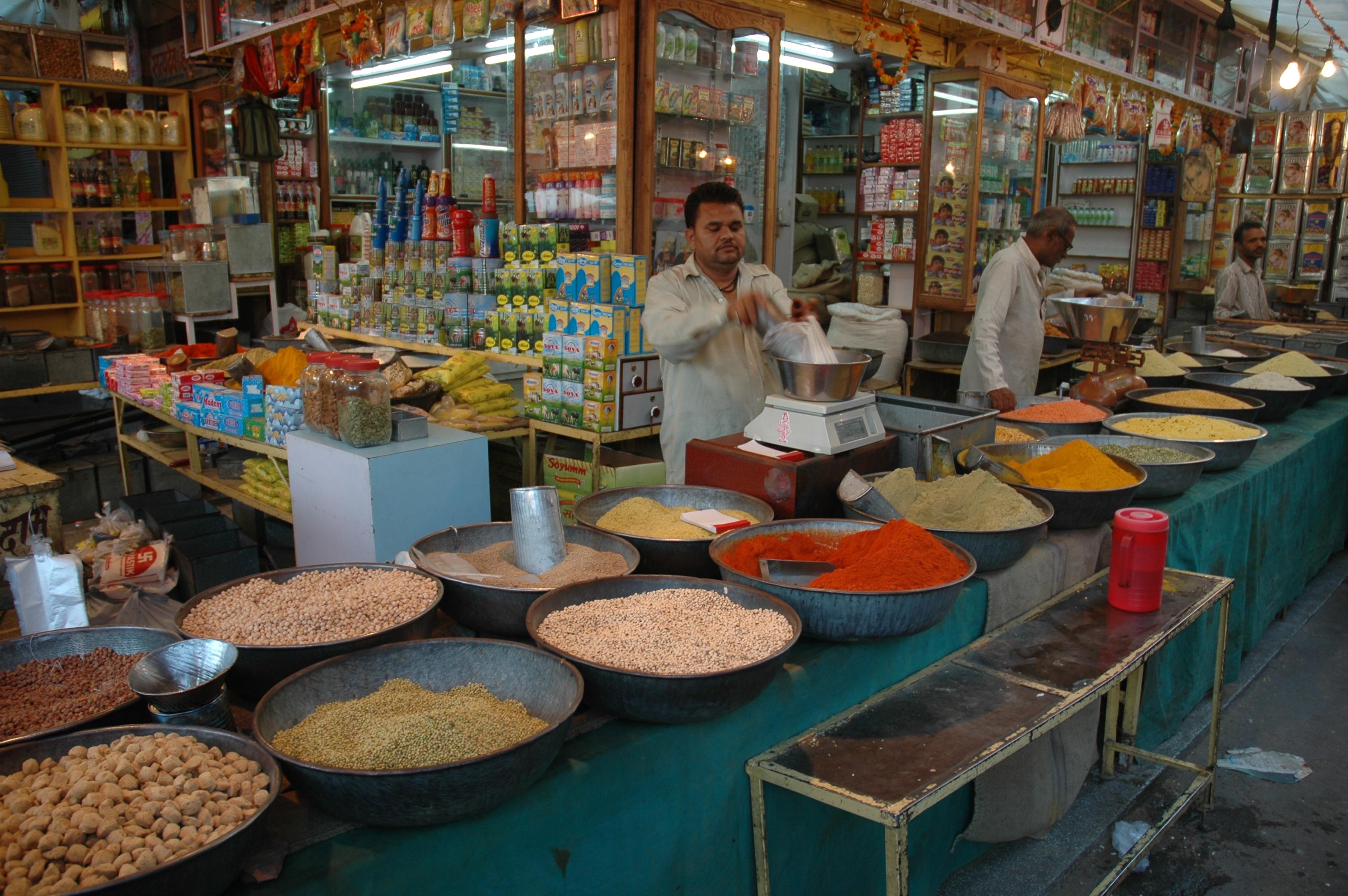 Spice shop in an Indian market with bowls of spices and pulses