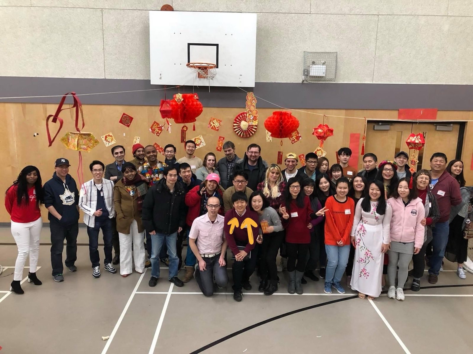 Andrew with a large diverse group indoors