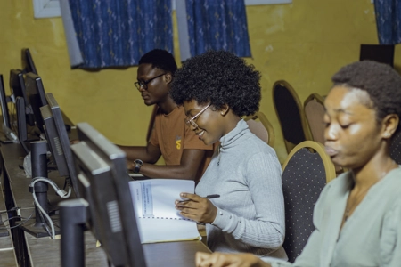 Des étudiants en salle d'informatique travaillant sur leur poste