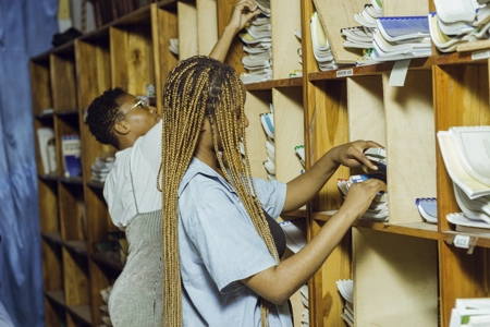 Deux étudiantes fouillant les étagères de la bibliothèque